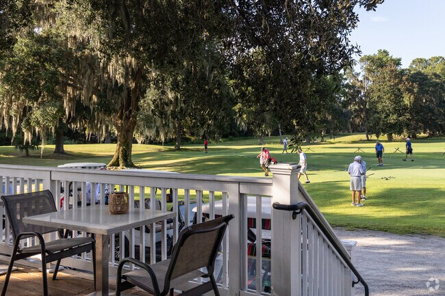 Enjoy a drink on the Fair Winds patio overlooking the practice gree at Rose Hill Plantation.