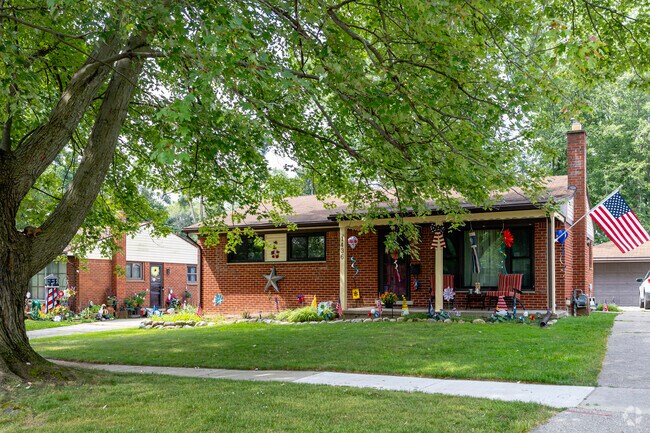 Smaller ranch homes are pocketed throughout Gault Village and shaded by trees lining the street.