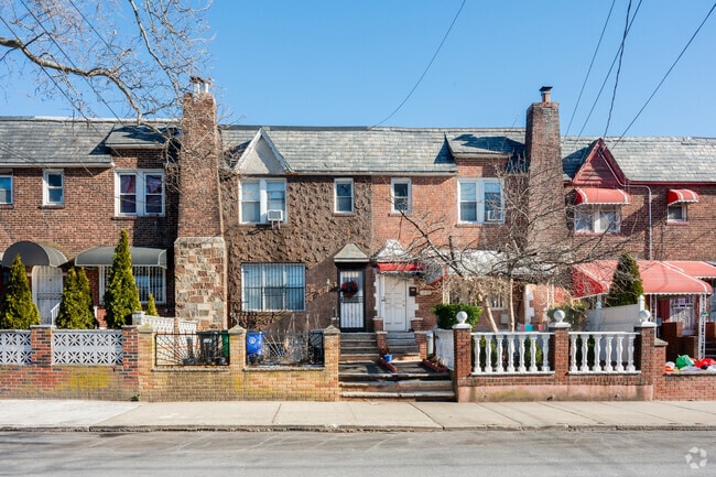 Semi-detached brick homes, with private parking around back in East Elmhurst.