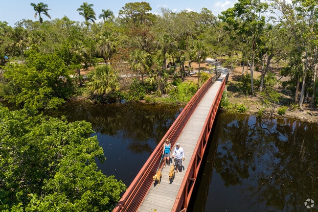 People walking on the footbridge across the Imperial River in Bonita Springs.