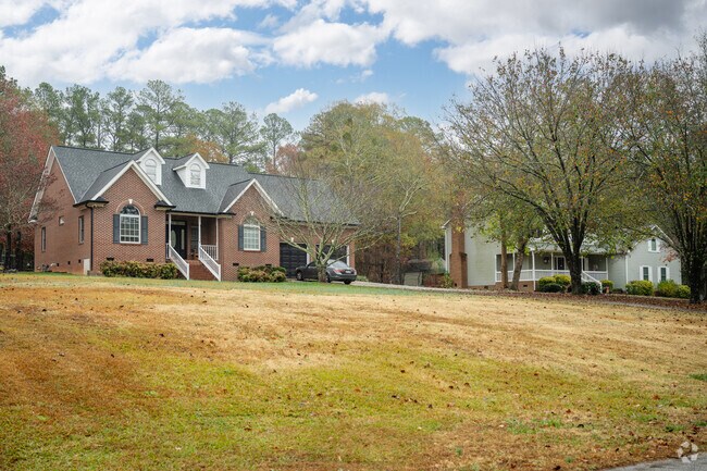 A pair of homes sitting on large plots of land surrounded by trees in Catawba.
