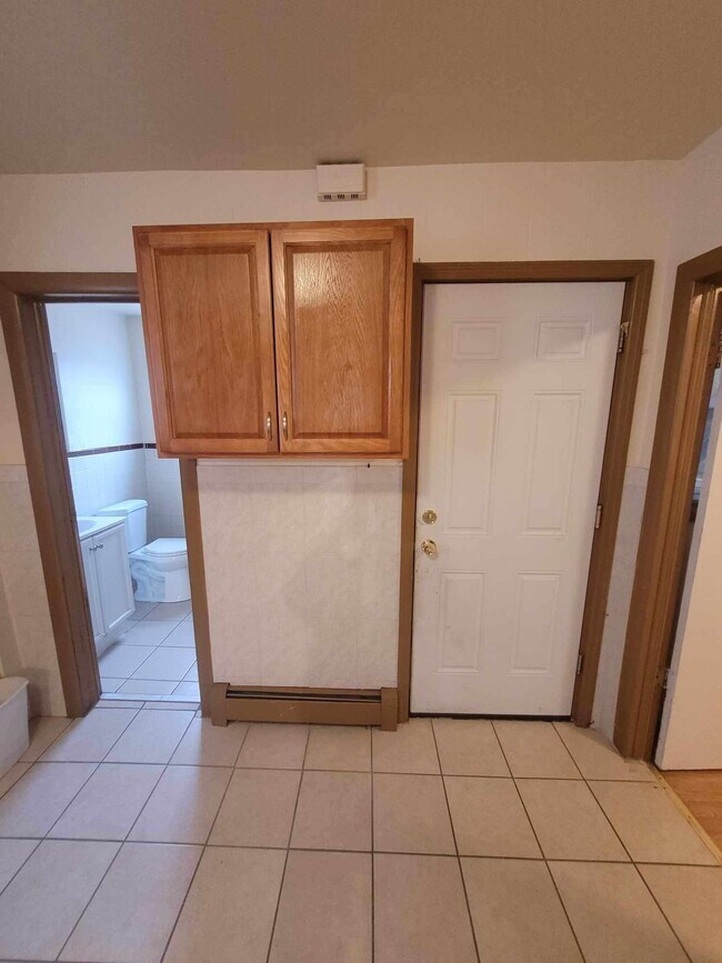 view from kitchen facing bathroom, backdoor for garbage, and bedroom 3 is to the right