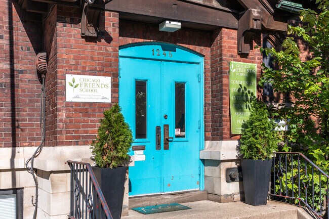 Students at Chicago Friends School pass through colorful blue doors as they enter the building.