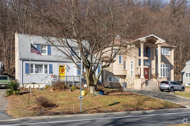 Two homes lie in Albion, NJ: craftsman-style and colonial-style.