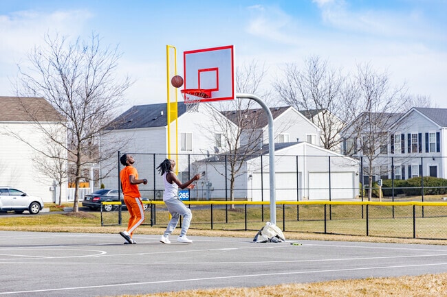 Friends enjoying a one-on-one basketball game at Century Park located in Wespark.