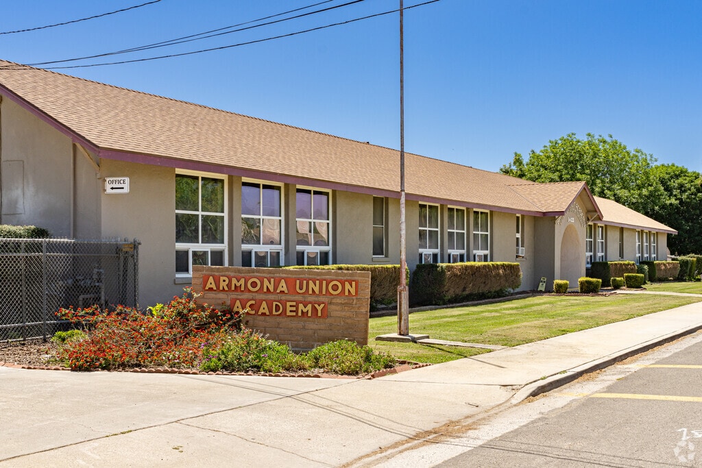 A brick sign at the entrance to Armona Union Academy welcomes students.