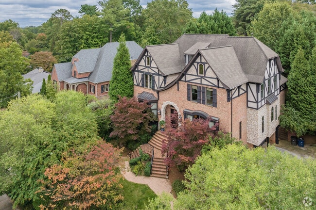 Along Runnymeade Rd, mansions rise above the trees in West Highlands.