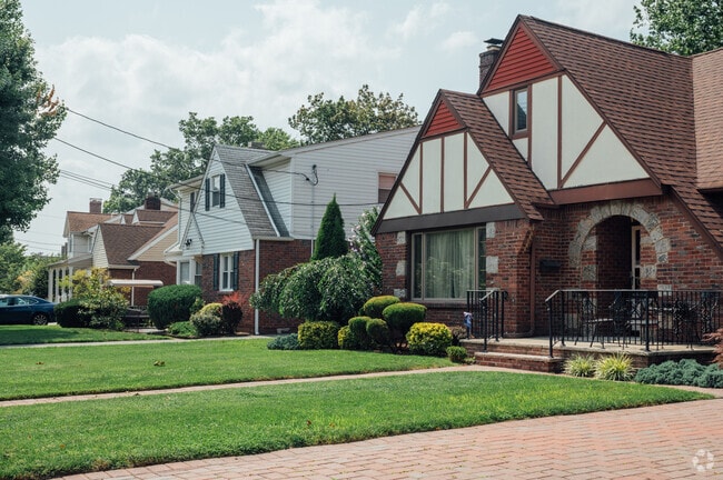 Extensive brickwork combines with Tudor style to bring charm to Elmwood Park, NJ.