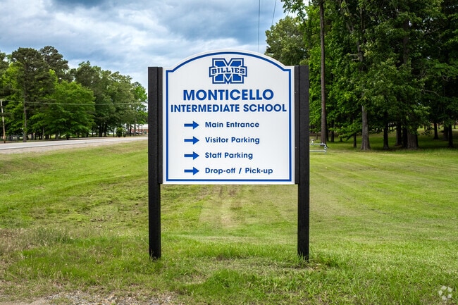 There is a sign for Monticello Intermediate School near the main road.