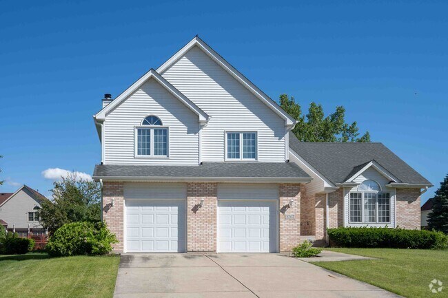 Beautiful brick and stone exterior homes have personal driveways and two car garages.