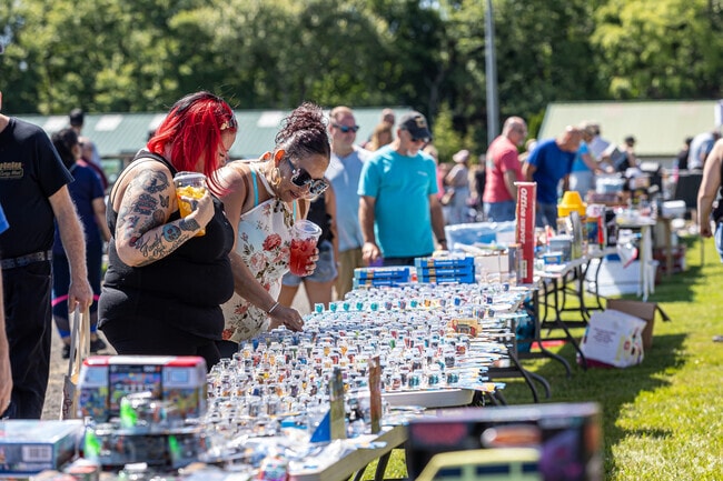 Shoppers enjoy browsing for parts and collectibles from Bug-A-Fair swap meet vendors near Plymouth.