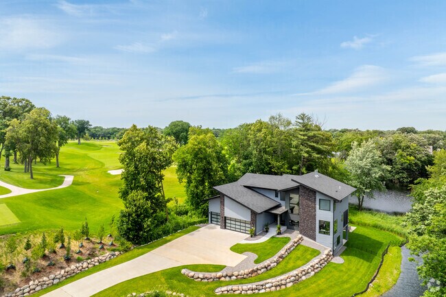 A modern-style house sits next to Interlachen Country Club.