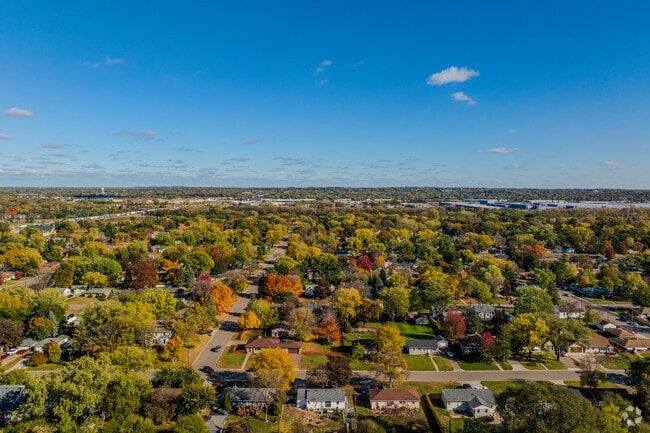 Grandview homes cluster near wooded areas and colorful foliage.