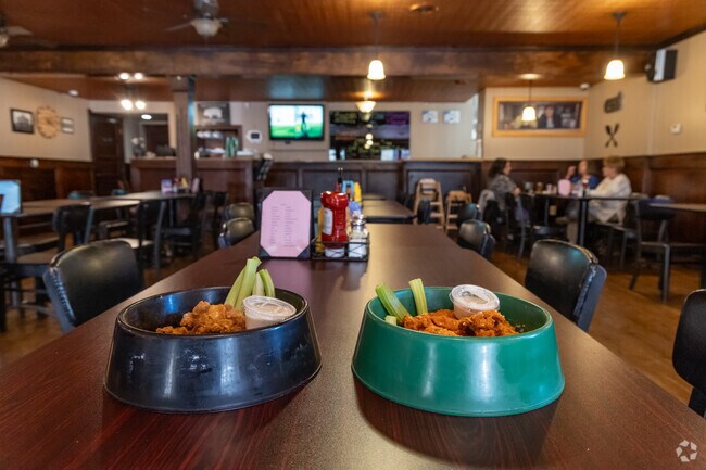 Make sure to try Hog' Head Bar & Grill iconic wings in a dog bowl.