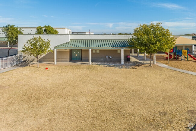 Fun in the bark play area at Mountain View School in Waddell.