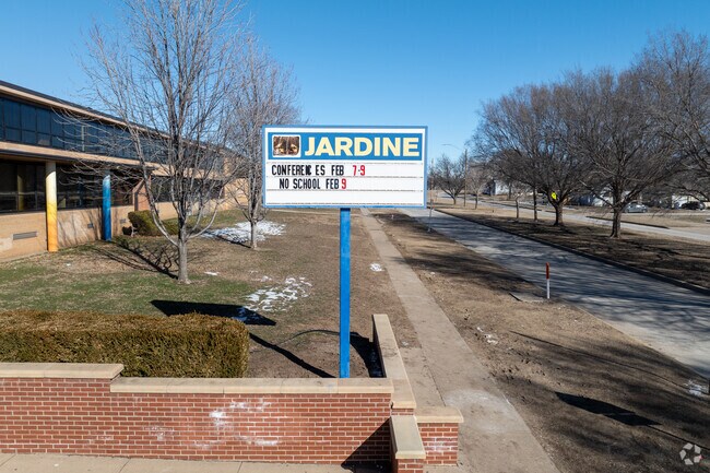There is a sign for Jardine Technology Magnet Middle School near the main road.