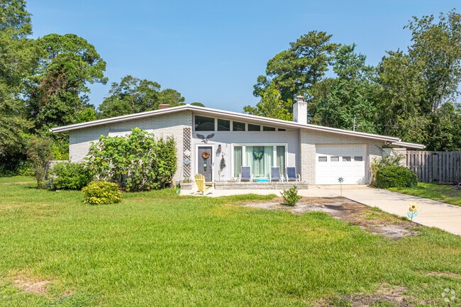 A front-gabled contemporary home in Lincoln Forest features a modern brick facade.