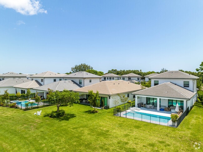 A row of well-manicured modern Spanish Revival homes in Banyan Cay.