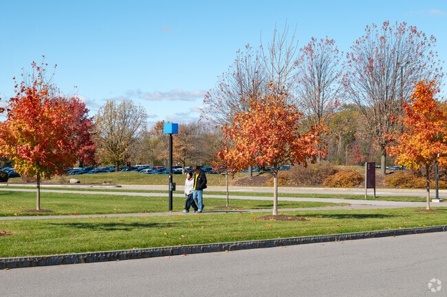 Two people walk through the Rochester Institute of Technology campus.