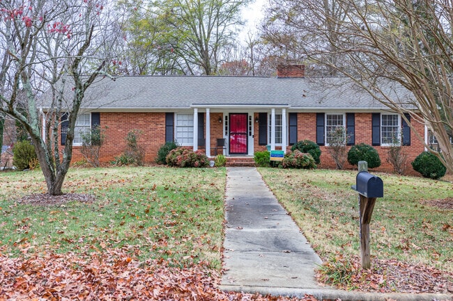 A brick ranch is located on a rural street in Hampton Sted-Mountain Brook.