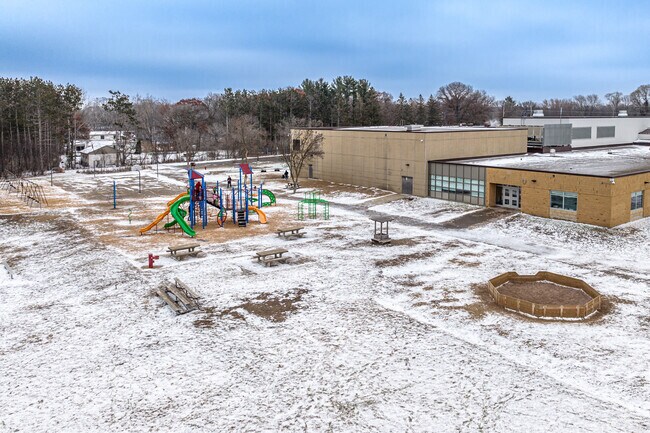 Lino Lakes Elementary features a large playground and green space behind the school.