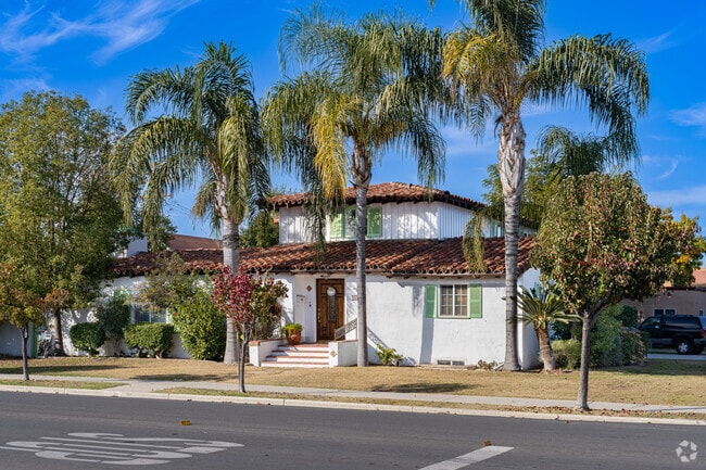 Large palm trees shade a mid 20th century Mediterranean home in Downtown Delano.