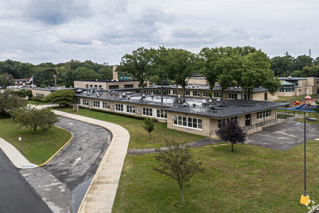 Wing Elementary School is surrounded by trees and greenery in Islip, NY.