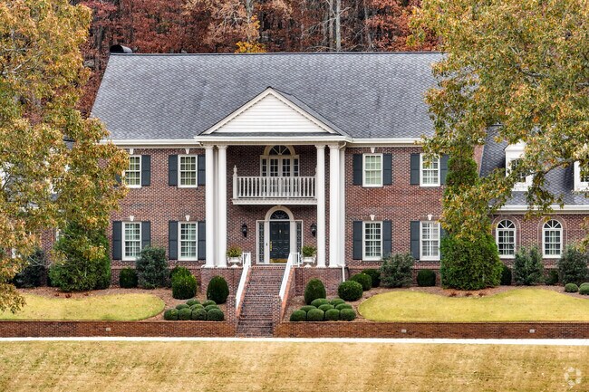 Large Federal style homes with long driveways occupy parts of Moontown.