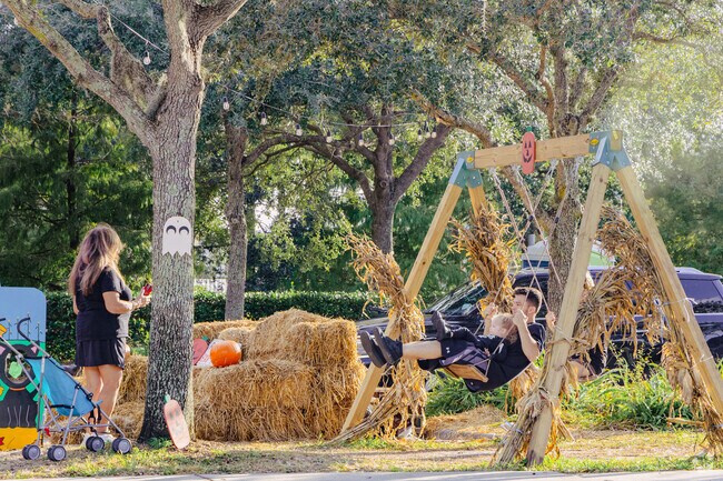 A young family enjoys the fall festivities in the Palm Beach Ranchettes neighborhood.