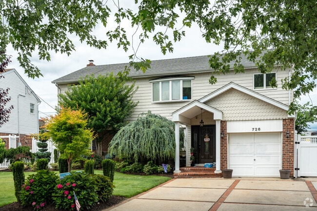 Find your charming colonial revival with scalloped siding.