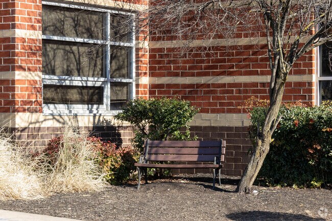 A bench sits on the side of Edgar Middle School in a quiet spot.