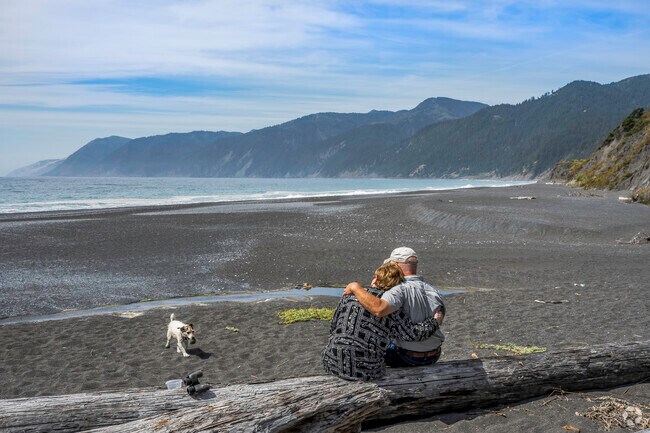 A loving couple enjoy the serenity of Black Sands Beach in Shelter Cove.