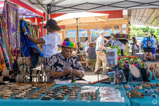 Artisans showcase handmade jewelry, wood carvings, and tie-dye clothing unique to Hawaii.