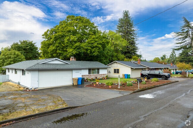 Two classic ranch-style homes stand side-by-side in the charming Oak Grove neighborhood, offering a glimpse into the quintessential American suburban lifestyle.