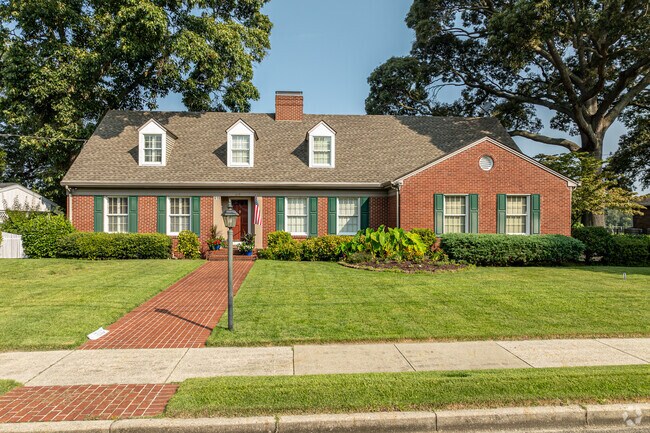This is a fine example of what a Cape Cod house could be with its dormers and garage.