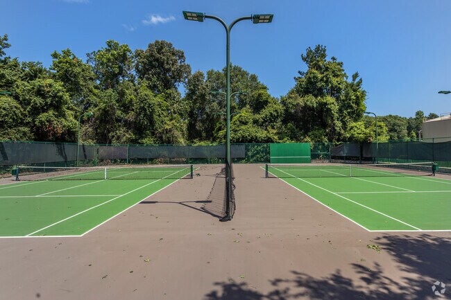 Residents enjoy a friendly game of tennis on the courts of Cardinal Sports Park.