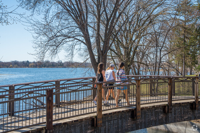 Pedestrians walk across the bridge next to Lake Nokomis parkway near Keewaydin.
