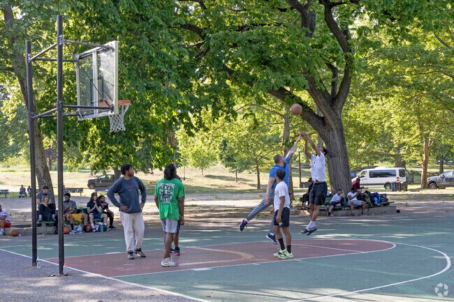 Residents of the Morrisania community enjoying a beautiful day at Crotona Park.
