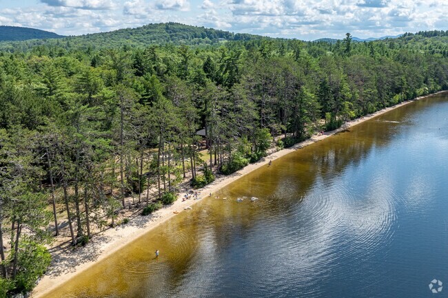 Residents enjoy the shaded beaches along the lake at Wadleigh State Park in Sutton, NH.