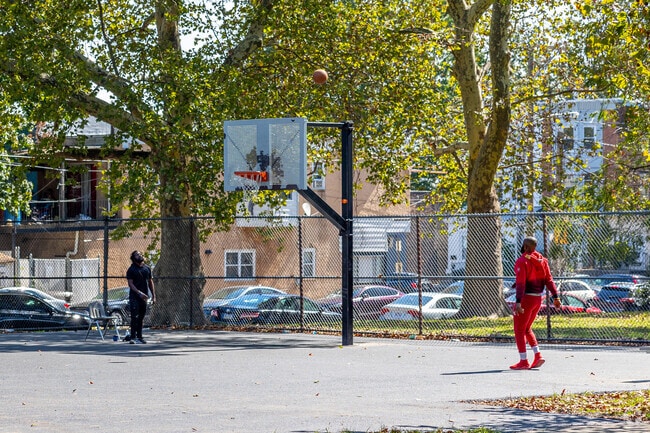 Residents shoot some hoops with friends in Paschall on the court at Connell Park.
