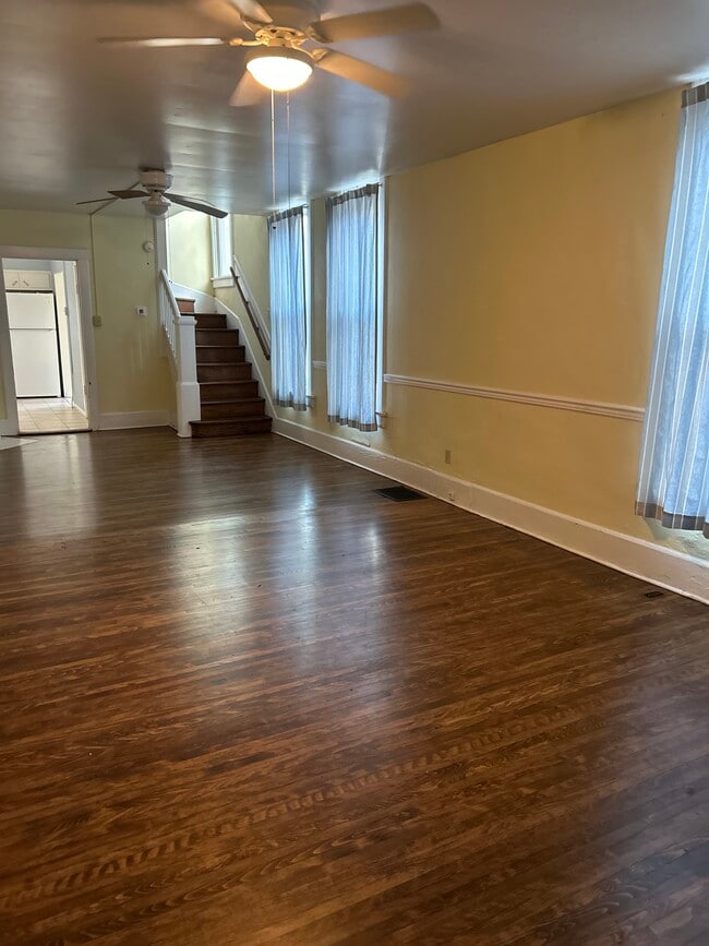 Living room. Carpet has been removed from stairs and hardwood refinished