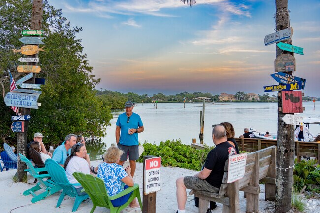 Casey Key Fish House's Tiki Bar located on the water offers Adirondack chairs to relax in.