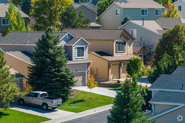 Homes with pale siding and brick accents are popular in Saddle Rock Ridge.