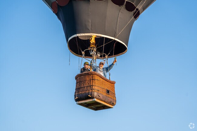 The pilot gives a thumbs up as they take off at Balloons Over Bend in the Old Farm District.
