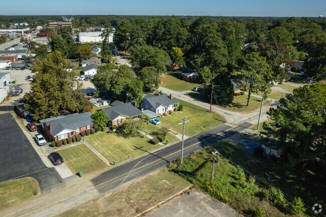 Many homes are surrounded by tall trees in the Green Acres area.