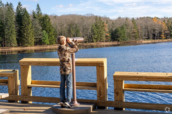 A young boy uses a telescope to view Black Moshannon Lake, a popular spot for Taylor folks.