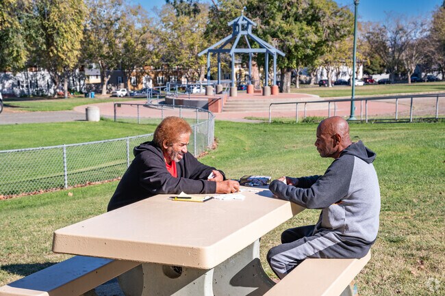 Fellows share a game of dominoes at Terrace Park.