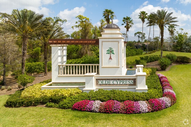 Olde Cypress residents are welcomed by an intricate sign with beautiful florals.