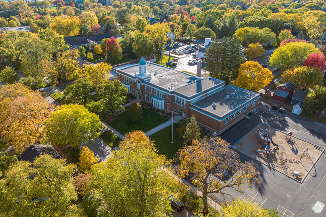 Naper Elementary School sits along a tree-lined street in Naperville, IL.