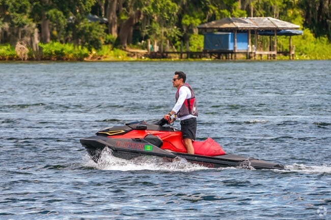 An Orwin Manor resident zips across Lake Sue by jet ski on a clear day.